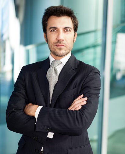 Professional man in a suit with arms crossed, exuding confidence, representing expertise in business consulting for Carolina Hyperbaric & Wellness.