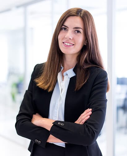 Professional woman in a business suit smiling confidently, representing the marketing team at Carolina Hyperbaric & Wellness.